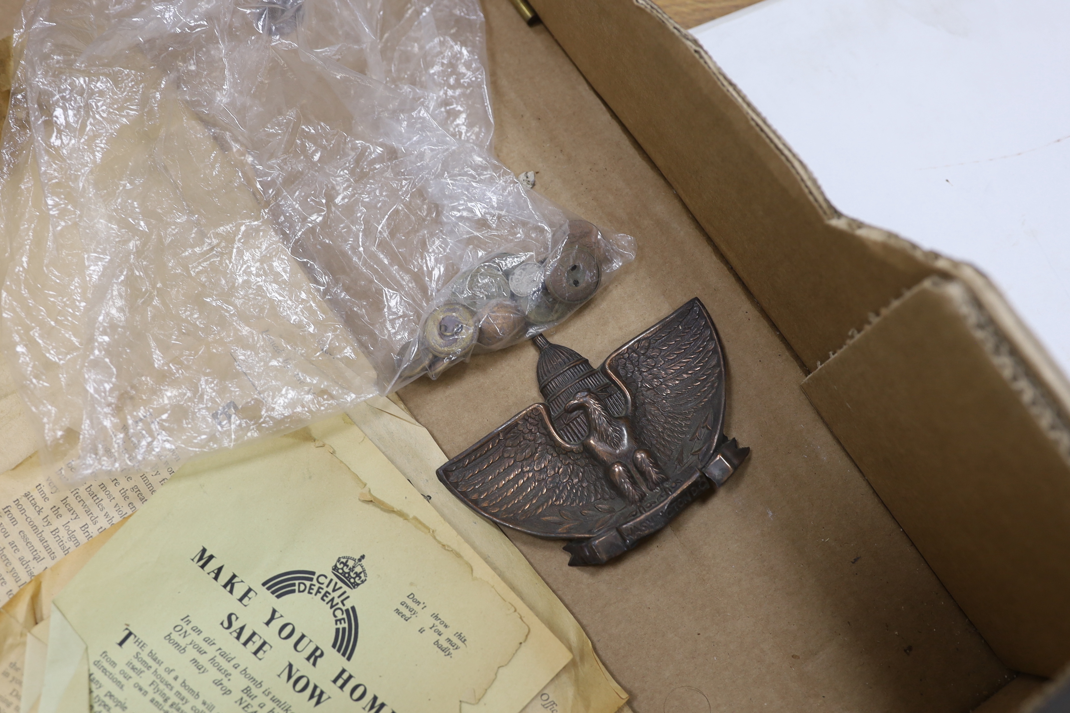 A collection of militaria, including a brass model of a Napoleonic era field gun, a stained glass panel, a Royal Air Force notebook, Civil Defence leaflets, etc.